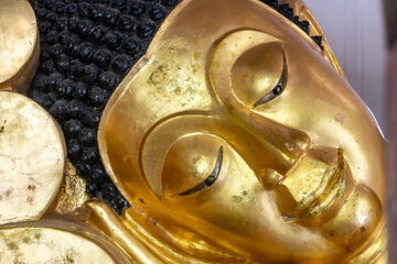 golden reclining buddha in Wat Phra Singh, Chiang Mai Thailand