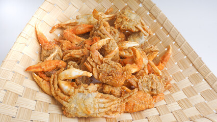 fried crabs on woven bamboo, street seafood beside the beach or path. selective focus