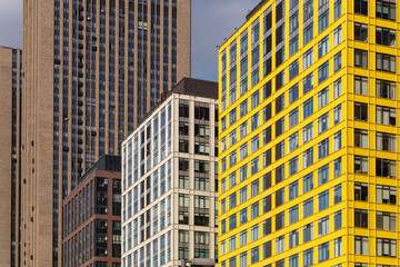 Facades of modern residential skyscrapers with lots of windows. Dense urban development. Problems...
