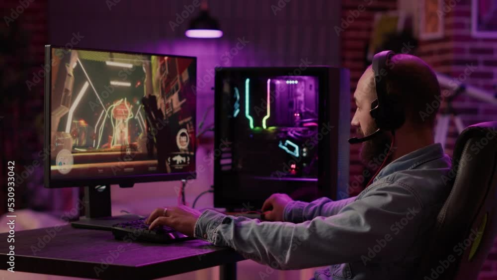 Poster static tripod shot of man using pc setup playing multiplayer online action game talking to team on h