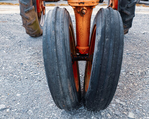Antique tractor wheels with tricycle front end.