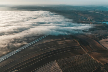Top view of dry fields, aerial photos of fields and fog with sunset light and clouds