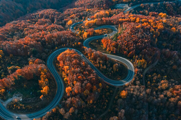 aerial photography of curved road on autumn, beautiful curved pass with vehicles and colorful...