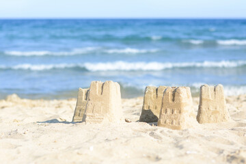 Beautiful sand castles on beach near sea