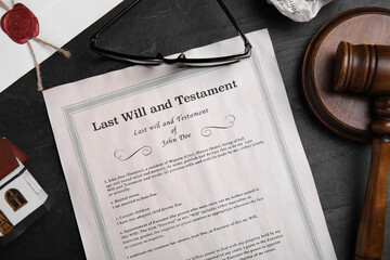 Last will and testament near house model, glasses, gavel on black table, flat lay