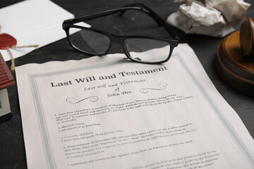 Last will and testament near glasses on black table, closeup
