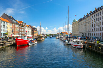 Fototapeta na wymiar Copenhagen, Denmark - July 10, 2018: The colourful boats and buildings of the Nyhavn district of Copenhagen 