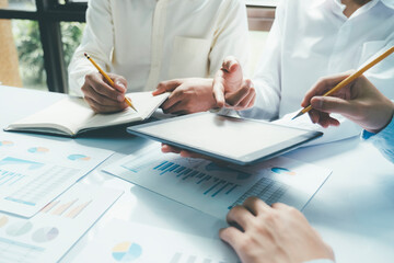 Startup asian business teamwork concept discussing graphs showing the results.