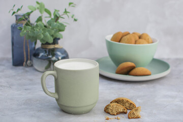 Glass with milk and oatmeal cookies on the table.