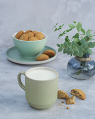 Glass with milk and oatmeal cookies on the table.