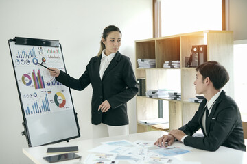 Asian businesswoman planning work in conference room with team