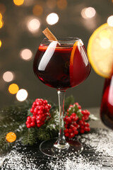Glass of delicious mulled wine on table