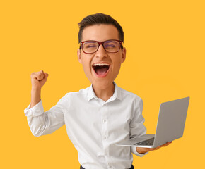 Happy businessman with big head and laptop on yellow background