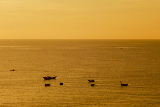 sunset on the beach and boats on the sea