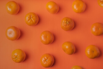 Fresh oranges on an orange background top view