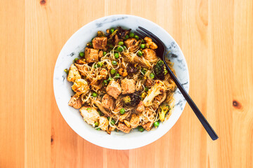 healthy plant-based food, vegan noodles stir fry with broccoli peas and marinated tofu chunks
