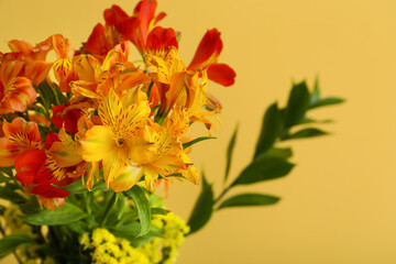 Beautiful bouquet of alstroemeria flowers on yellow background