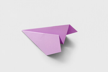 Lilac paper plane on grey background