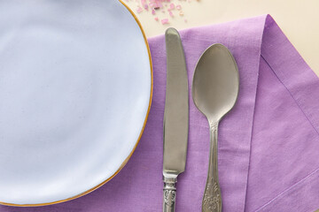 Plate, cutlery and napkin on light background, closeup