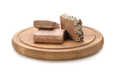 Wooden board of tasty sesame halva on white background