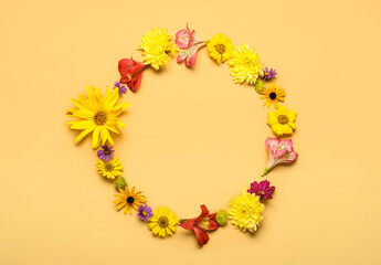 Frame made of beautiful autumn flowers on color background