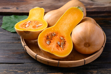 Butternut squash or butternut pumpkin in basket on wooden background