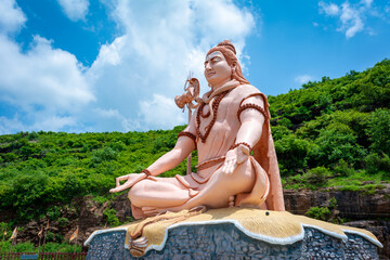 Hindu god Shiva sculpture sitting in meditation. Yoga and meditation concept.