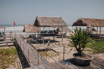 Danang, Vietnam - March 7th, 2020 : wooden constructions in a restaurant on the beach with wooden...