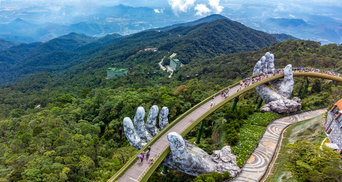 Golden Bridge lifting by two giant hands in the tourist resort on Ba Na Hill in Da Nang, Vietnam.
