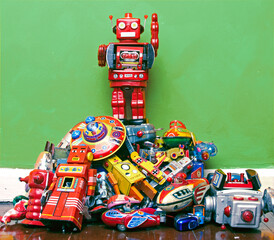 robot toy stands on the oppressed green background 