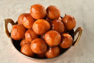 luqaimat or lokma. Freshly fried Lokma (luqma - arabic) piled high a popular middle eastern dessert of small dough balls deep fried then coated in sugar or honey syrup
