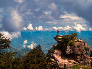 Clouds over the mountain. NARKANDA, INDIA - JULY 15, 2022: Hatu Mata Temple on the summit of the Hatu Peak mountain in Himachal Pradesh, India near Narkanda. 