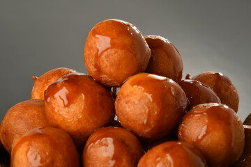 luqaimat or lokma. Freshly fried Lokma (luqma - arabic) piled high a popular middle eastern dessert of small dough balls deep fried then coated in sugar or honey syrup
