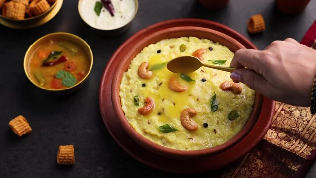 Ven Pongal Khara Pongal Sambar coconut chutney woman hand serving Indian breakfast food Tamil Nadu festival Pongal Sankranti Diwali spicy pongal using rice lentil semolina rava South India Sri Lanka