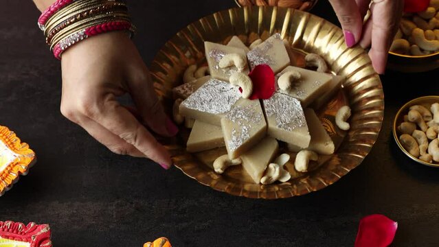 Kaju Katli Kaju Barfi Burfi cashew fudge candy woman hand serving Indian sweet mithai festival dessert Diwali Dussehra Holi ganesh chaturthi Ram navami Durga pooja Navratri Mumbai Kerala Sri Lanka