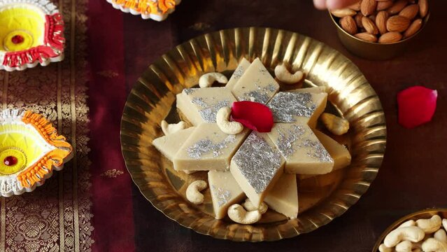 Kaju Katli Kaju Barfi Burfi cashew fudge candy woman hand serving Indian sweet mithai festival dessert Diwali Dussehra Holi ganesh chaturthi Ram navami Durga pooja Navratri Mumbai Kerala Sri Lanka