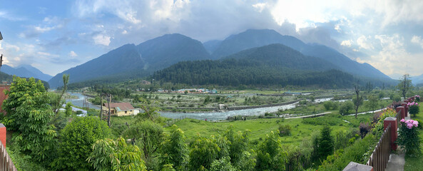 View of the mountains, valleys, and a river in rural India.