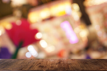 Empty dark wooden table in front of abstract blurred bokeh background of restaurant . can be used for display or montage your products.Mock up for space.