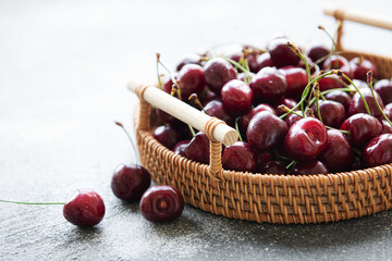 Fresh red cherries fruit on wicker tray