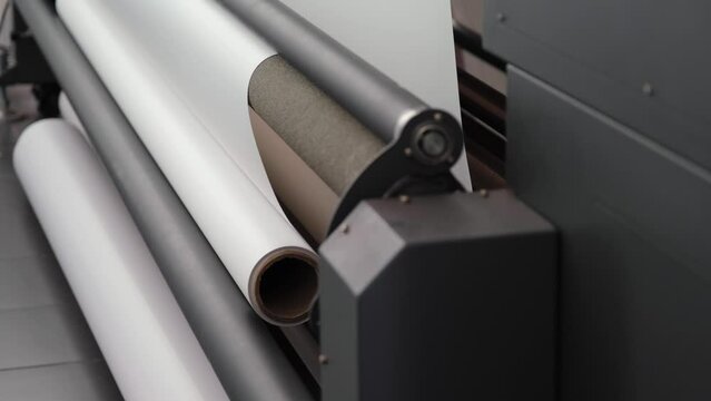 Back view of the digital printing machine. Coil details of digital printing machine. Mechanism that wraps the printing material.