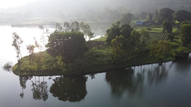 Lush Lake Shore Farmland On A Sunrise In Trimbakeshwar, Nashik, India. aerial drone