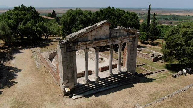 Cinematic aerial shot in orbit and in the archaeological park of Apollonia where the structure of the BOULEUTERION can be seen, in Albania.