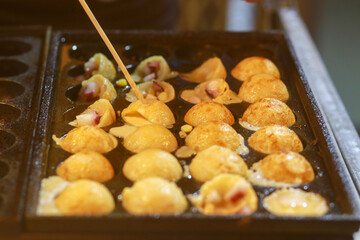 Takoyaki being prepared in Ho Thi Ky street food