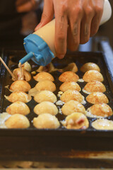 Takoyaki being prepared in Ho Thi Ky street food