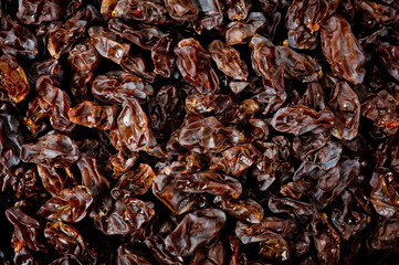 Close-up shot of freshly dried dark-colored raisins.
