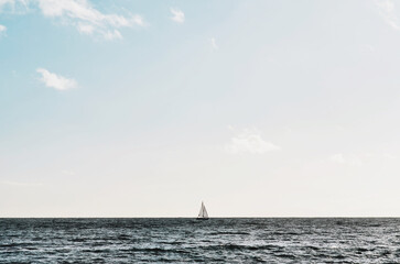 Fototapeta premium a sailboat sailing across the horizon sea