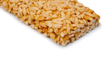 Poster Sweetness from grains of puffed rice, shot close-up on a white background. © Pavlo