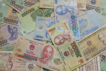 Fototapeta na wymiar Vietnamese dong banknotes close-up. Money background. Vietnamese currency - dongs. Pattern texture and background of Vietnam dong money, currency banknotes ready for exchange and business investment.