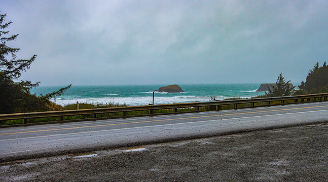 ocean view along a rain-covered highway