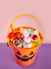 Naklejka premium Halloween Jack o Lantern orange bucket with candy